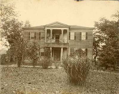 Photograph of Mordecai Plantation house in Raleigh, N.C., ca. 1897, from the collection of the NC Museum of History. The home was originally built in 1785 and then enlarged and restyled in the 1820s in the Greek Revival style popular during the era.