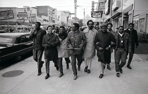 On February 14,1969 members of the SCLC marched in Raleigh to protest closing of traditional black schools in Hyde County when integration evidenced gross cultural inequities there. Bennie Rountree participated in this march and is shown in the photo on the right, wearing a hat. Golden Frinks is standing in the middle of the group, with an item in his hands, and the Rev. Andrew Young is shown one from the left in the front. Image from the N&O Collection at the State Archives of NC. Copyright the News and Observer, used by permission.