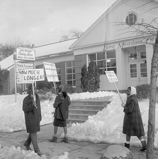 Discrimination at Long Meadow Farm Dairy Store (1960) Photograph of individuals protesting discrimination at the Long Meadow Dairy Farm store, 1960.