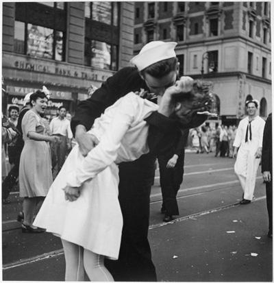 The Kiss - V-J Day A sailor kisses a nurse on a busy street. They are both wearing their work apparel.