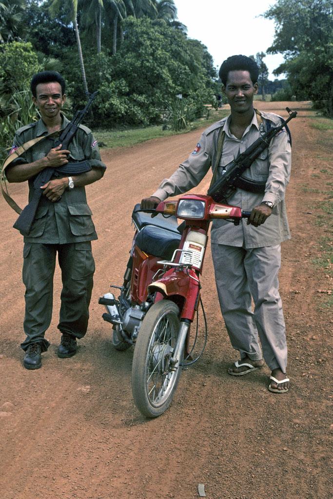 <img typeof="foaf:Image" src="http://statelibrarync.org/learnnc/sites/default/files/images/vietnam_202.jpg" width="683" height="1024" alt="Two guards with machine guns who escort tourists to Banteay Srei Temple" title="Two guards with machine guns who escort tourists to Banteay Srei Temple" />