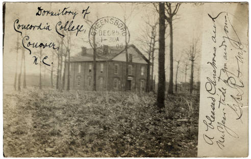 Photo of Concordia College dorm. It is a brick building in a wooded clearing.
