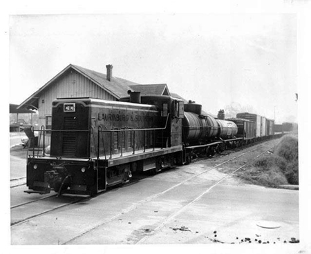 Warehouse and train of the Laurinburg & Southern Railroad, Laurinburg, N.C., 1953. Image from the North Carolina Museum of History.
