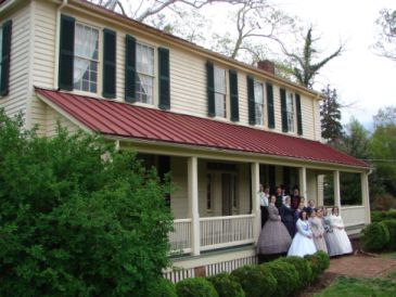 Burwell School with reenactors gathered for a family photo on the porch. Image courtesy of Burwell School Historic Site. 