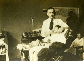 Dr. George M. Cooper with patient  Dental clinic at Badin, NC, Stanly County, 3 march 1921. From the Dr. George M. Cooper Photograph Collection,  North Carolina State Archives, Raleigh, call #:  PhC41_F24_188. NC.