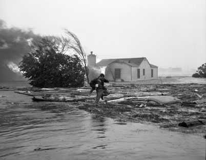  "Julian Scheer wading through debris after Hurrican Hazel (1954), Carolina Beach, NC."  Image courtesy of UNC Libraries. 