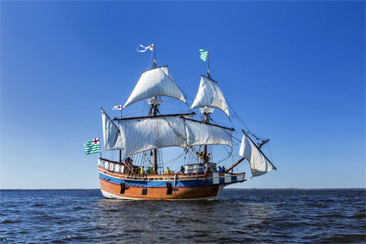 Photograph of the <i>Elizabeth II</i>, a representational ship launched in 1983 for the 400th anniversary of the Roanoke Voyages in 1984.  The ship is moored at Festival Park in Manteo, NC and is a composite representing the characteristics of the merchant ships of the Roanoke Voyages. Image by Jay Watkins, NC ECHO, courtesy of the North Carolina Department of Cultural Resources.