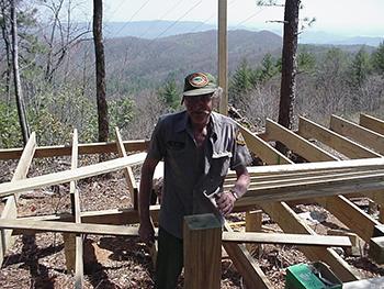 Park staff building a structure with a scenic view behind the work site, Gorges State Park. Photograph, April 11, 2001. North Carolina Division of Parks and Recreation.