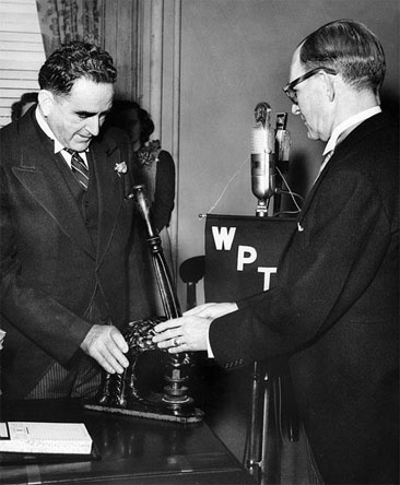 Photograph of Gov. Kerr Scott passing the Great Seal of NC to Gov. William Umstead, January 1953.  Item H.1966.109.14 from the North Carolina Museum of History. Used courtesy of the Department of Cultural Resources. 
