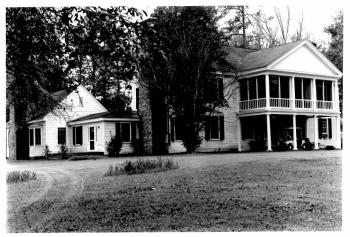 Black and white photograph of Long Valley Farm, ca. 1993. From the National Park Service National Register of Historic Places registration form for Long Valley Form, 1993.  Today the farmhouse and property form a portion of Carvers Creek State Park.