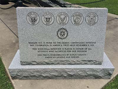 Photograph of the granite monument at the Duplin County Veterans Howitzer monument, Warsaw, N.C.  The marker acknowledges the first annual occurrence of the Warsaw parade on November 11, 1921.  Photograph courtesy of Commemorative Landscapes of North Carolina.
