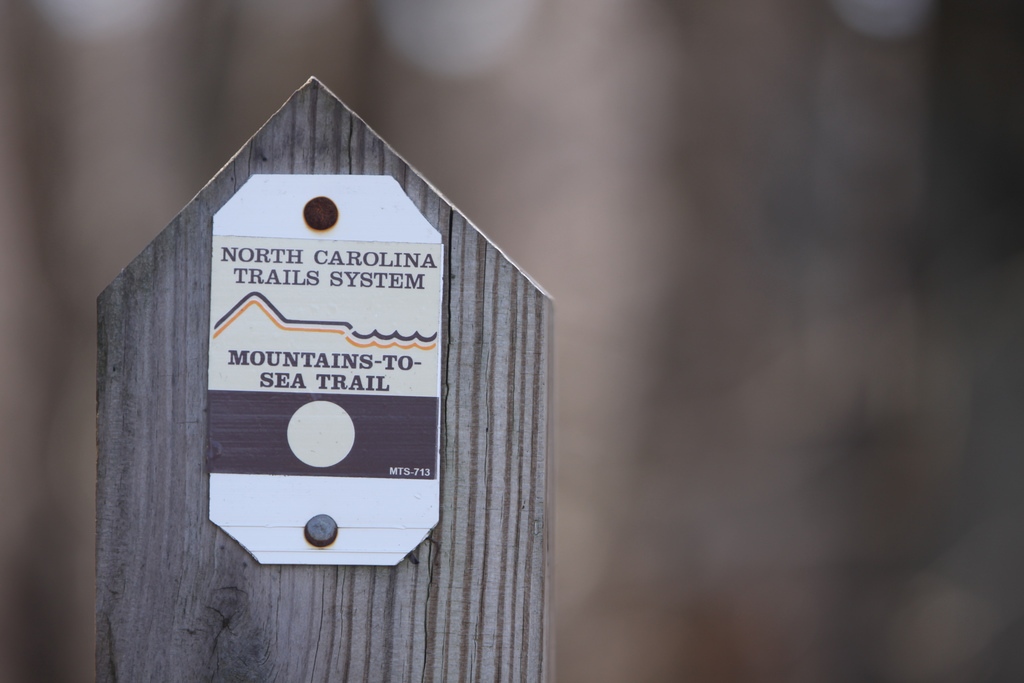 Mountains-to-Sea Trail signpost marks it as a project of the North Carolina Trails System.