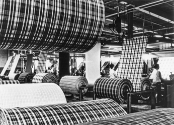 Inspectors examine newly woven fabric at the Burlington Industries mill in Mooresville, ca. 1960. North Carolina Collection, University of North Carolina at Chapel Hill Library.