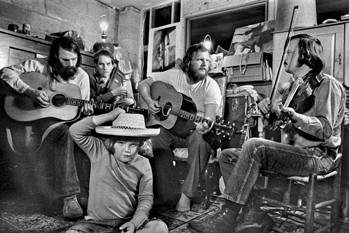 The Red Clay Ramblers practice in Tommy Thompson's basement in Chapel Hill, ca. 1974. Left to right: Jim Watson, Mike Craver, Tommy Thompson, and Bill Hicks. Thompson's son, Tom Ashley, is in the foreground. Photograph by John Rosenthal.