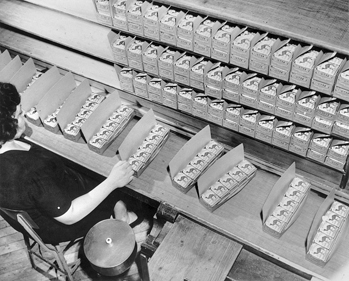 Inspecting cartons of Camel cigarettes at R. J. Reynolds Tobacco Company. North Carolina Collection, University of North Carolina at Chapel Hill Library.