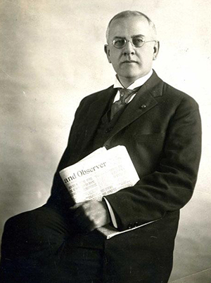 Marshall De Lancey Haywood, holding a copy of the Raleigh News and Observer, circa 1921. Image from the North Carolina Museum of History. 