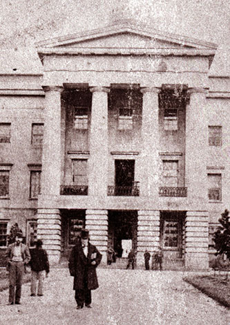 A photograph of David Settle Reid (in top hat) in front of the capitol building in Raleigh, circa 1861. Image from the State Archives of North Carolina.