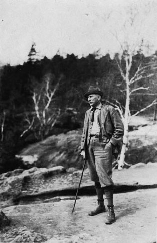 "The Doctor Himself, Spring 1926." Kallitype photograph of Carl Alwin Schenck posing on a rocky outcrop; taken by "ah," taken 1920s. Item MC00035, Special Collections Digital Resources, Special Collections Research Center, North Carolina State University Libraries.  Used by permission. 