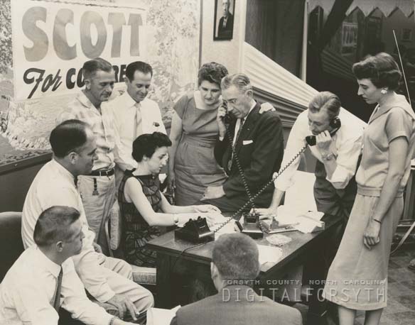 "Ralph Scott headquarters for his congressional renomination, 1958. Mr. Scott is the man on the left talking on the telephone. His wife stands beside him. Mr. Scott won the renomination election," from Digital Forsyth, published 1958 by Forsyth County Public Library. Presented on Digital Forsyth.