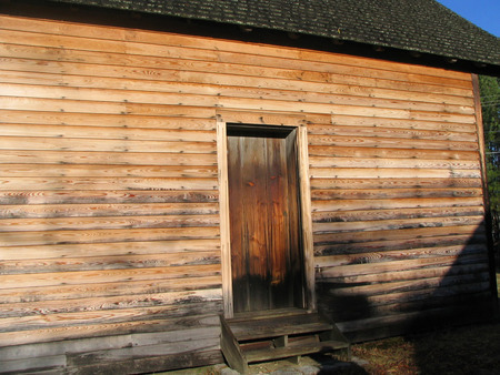 Kent McCoury (l) and Peter Hymas in front of the Bennett's log cabin kitchen