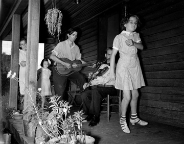 Asheville Mountain Music Festival Asheville August 1938, photo taken by Baker. The musicians are Osey and Ernest Helton. Conservation and Development Department, Travel and Tourism Division Photo Files, North Carolina State Archives, call #:  ConDev1424C. 