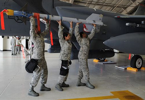 "Crew from the 333rd Aircraft Maintenance Unit attempt to load an AIM-9 Sidewinder missile onto an F-15E Strike Eagle at Seymour Johnson Air Force Base, N.C., Aug. 2, 2012."
