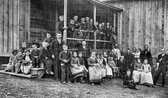 Waldensian schoolchildren and teacher (standing beside steps) at Valdese, ca. 1905. North Carolina Collection, University of North Carolina at Chapel Hill Library.
